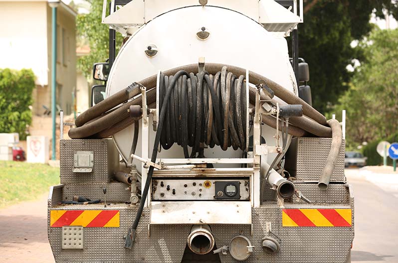 A restoration tanker trucker used in water extraction to pump out and hold water or sewage after a flood or backup