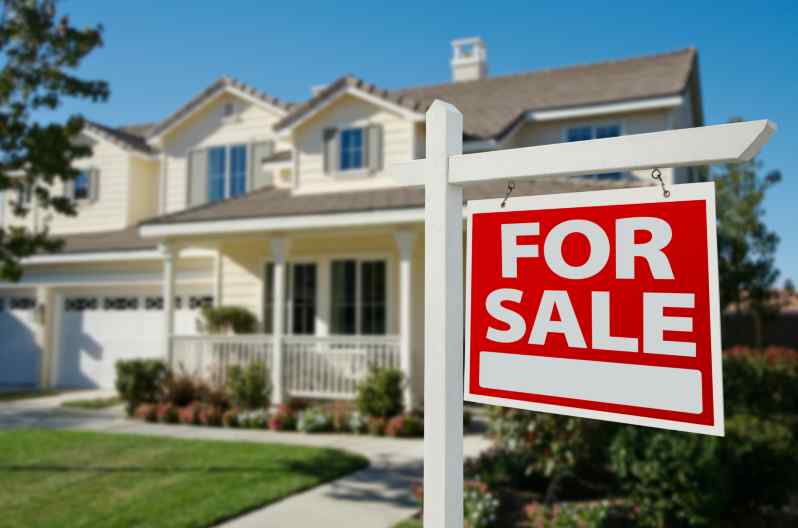 For sale sign in front of a house