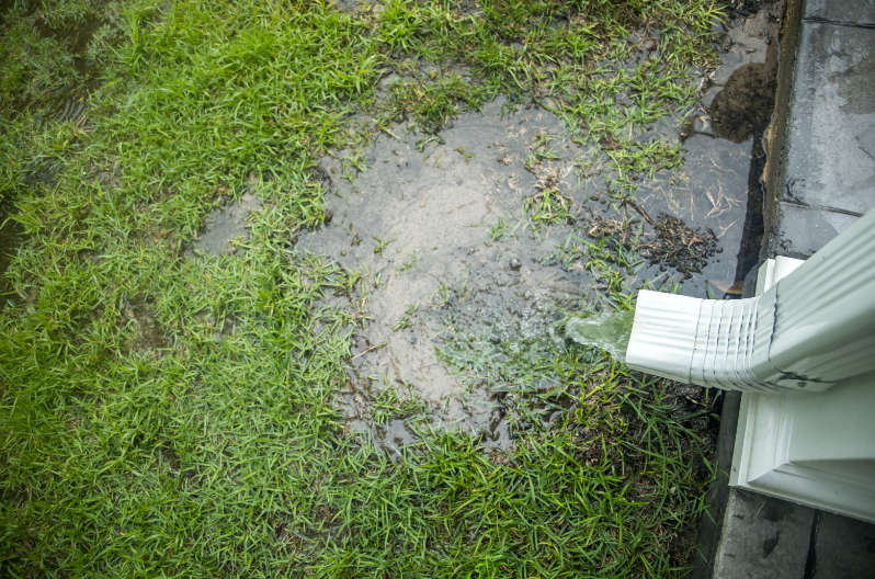 Rainwater flooding a yard because of poor drainage. Here are several ways of diverting water away from your home’s foundation to prevent floods.