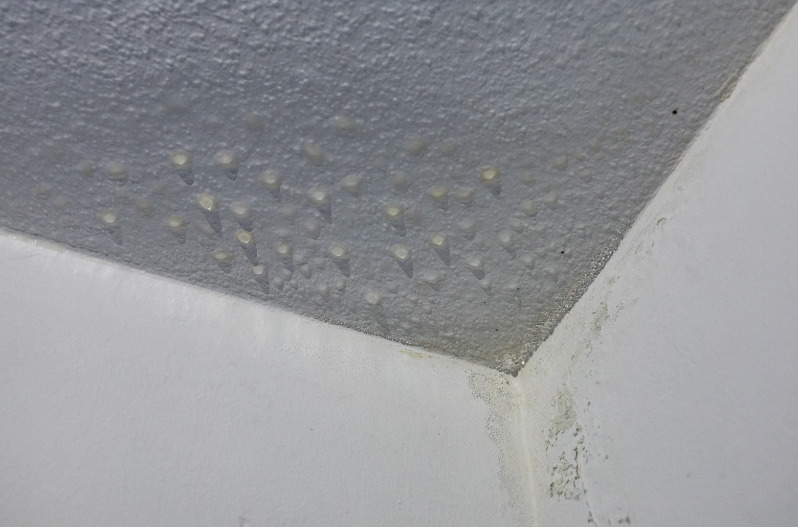 Condensation and moisture stains on the ceiling in a bathroom